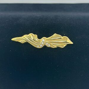 Gold tone bow brooch with gemstone